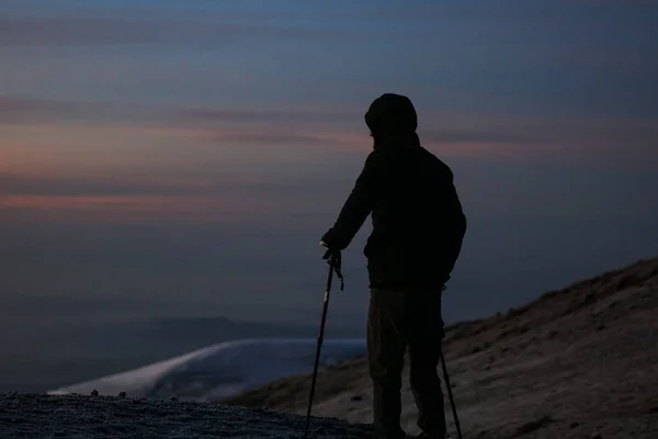 独自雄在高山乞力马扎罗 站在和思考自然 生活和未来 在这里和现在 自由和力量 在岩石上攀登极限 非洲野生景观 — 图库照片