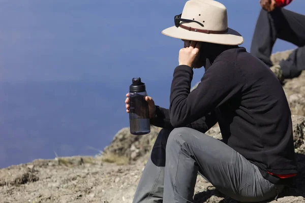 Young Handsome Man Sitting Rock Drinking Water Enjoys Amazing Nature — Stockfoto