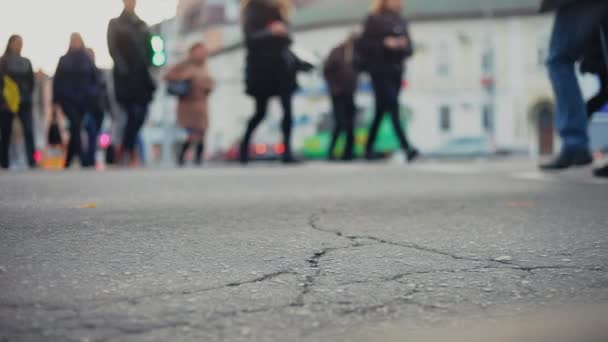 Unrecognizable people walk at crosswalk at a crossroads — Stock Video