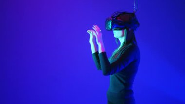 Güzel genç kız modern vr gözlük kullanın. Kadın şeye saygısız, itmek, modern sanal gerçeklik gözlükleri, yan görünümü kullanarak artış