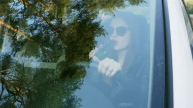 Woman drinking alcohol while driving, traffic offense drunk driver