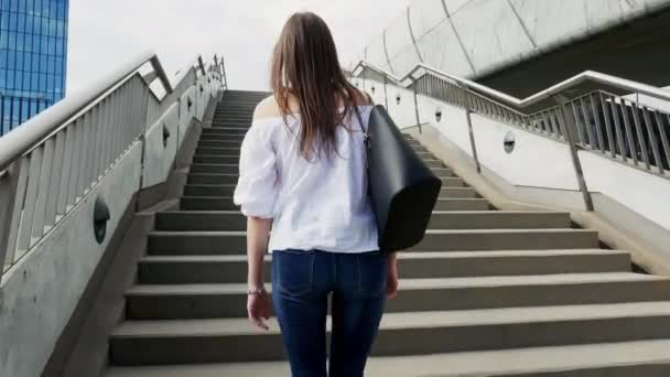 Mladá žena kráčí po schodech na ulici města — Stock video