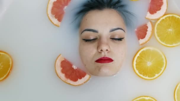 Close-up retrato de bela mulher rosto no banho de leite cheio de frutas , — Vídeo de Stock