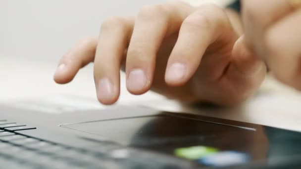 Erkek elinin yakın çekimi laptopta dokunmatik pedi kullanır, parmağıyla hareket eder. — Stok video