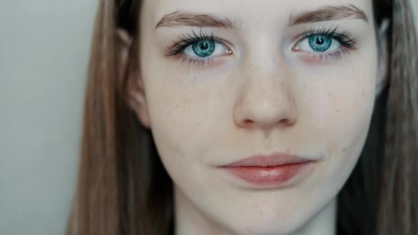 Close-up van jong mooi blauw ogen, jong tiener meisje kijkt naar de camera — Stockvideo