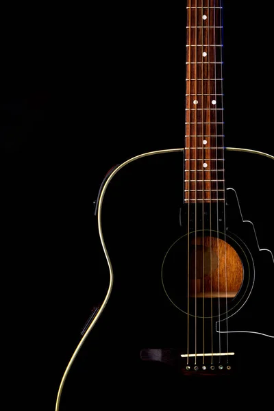 musical instrument wood acoustic six-string guitar isolated on blackbackground