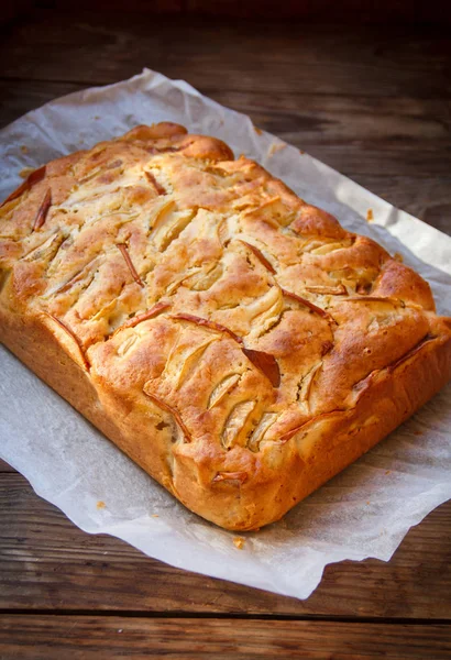 Fresh cakes. Apple pie on a wooden table. Country style