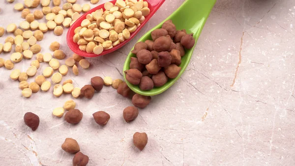 Black Chickpeas or Kala Chana with chana dal pulse isolated on wooden Background.