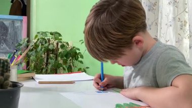 Evde kalemlerle resim çizen sevimli bir okul çocuğu. Yaratıcı bir işle uğraşıyor. Hobisine odaklanmış, evde boş vakit geçirirken hayal gücü ve sanatsal beceriler geliştiriyor.. 