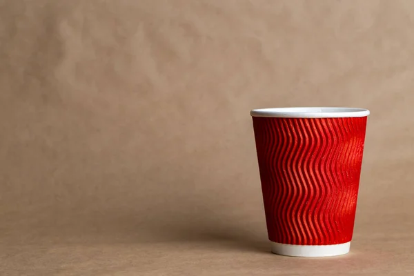 coffeeto  go in a disposable cup on a craft background, place for tex