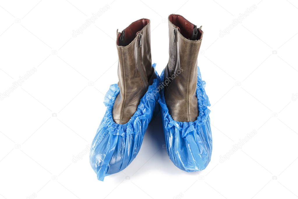 blue medical shoe covers on boots. Isolated on white background