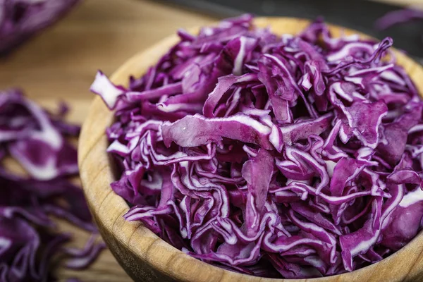 chopped purple cabbage. salad of useful violet cabbage on a wooden backgroun