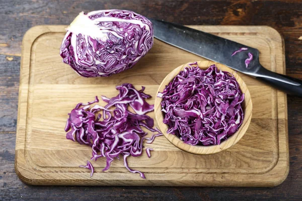 chopped purple cabbage. salad of useful violet cabbage on a wooden backgroun