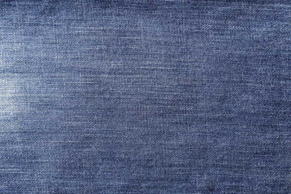 blue old denim background. well visible texture of the fabric. place for tex