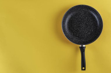 sarı bir arka plan, üstten görünüm üzerinde yeni boş kızartma tavası. tex için yer