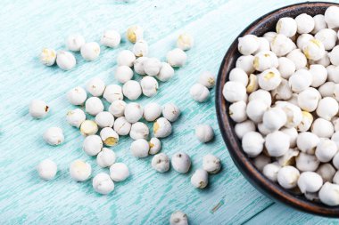 mavi bir eski püskü masaya bir tabak içinde ham baklagiller nohut. tex için alan