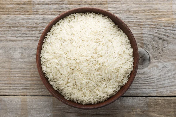 raw long rice in a plate on a wooden table. traditional asian foo