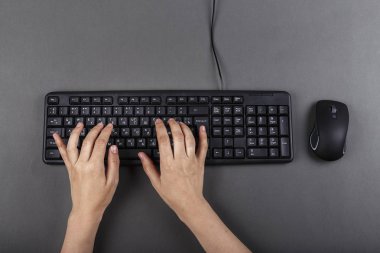 female hands on a black computer keyboard. business planning. work with office equipmen clipart