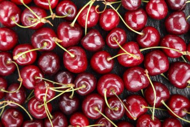 Olgun kırmızı tatlı kiraz arka plan olarak dağılmış. tex için alan