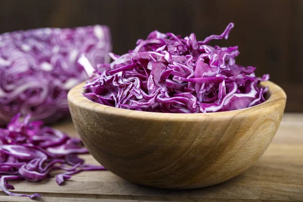 chopped purple cabbage in a plate on a cutting board. space for tex