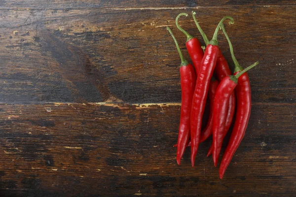 Bunch Hot Red Peppers Brown Wooden Background Space Tex — Stock Photo, Image