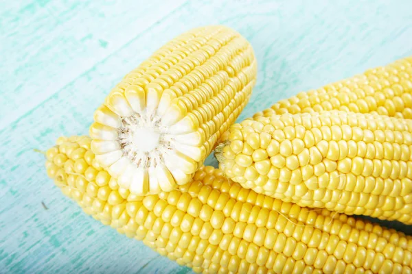 Fresh corn on cobs on rustic wooden table — Stock Photo, Image