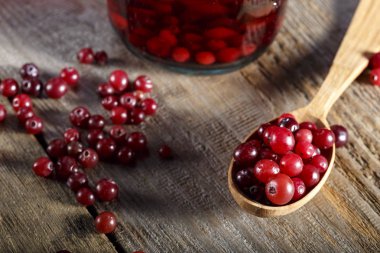 Fresh cranberries in a wooden spoon