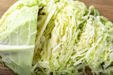 Chopped savoy cabbage on a wooden board.
