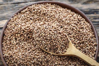 bir karabuğday arka plan üzerinde bir ahşap plaka içinde ham karabuğday groats. 