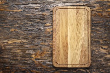 Dikdörtgen ahşap kesme tahtası bir arka plan olarak açık ahşaptan yapılmış - metin için alan. kahverengi ahşap backgroun üzerinde