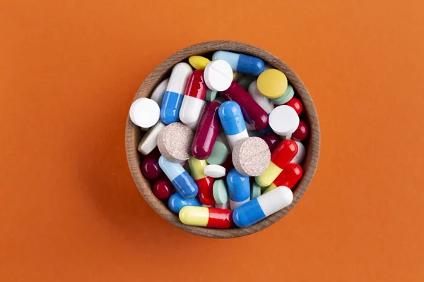 a lot of multi-colored tablets in a plate