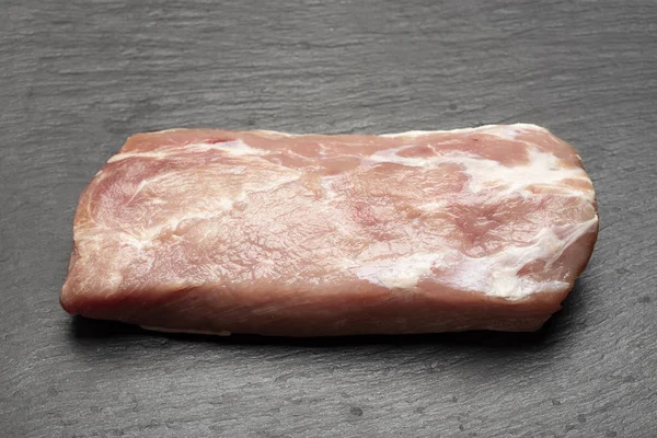 Pork meat on a black background — Stock Photo, Image