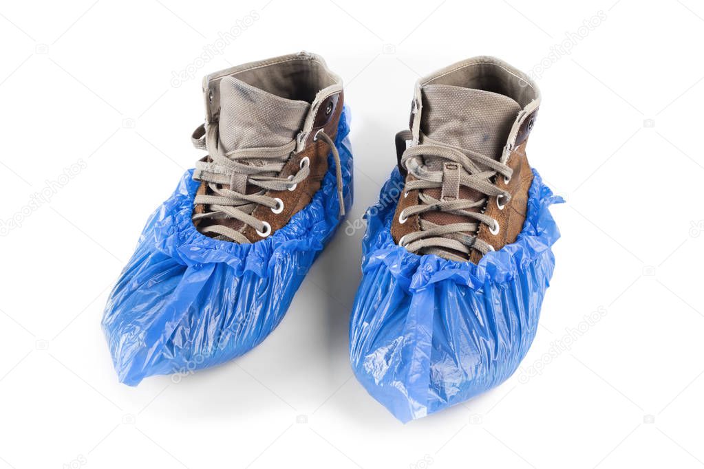 boots in shoe covers on a white background