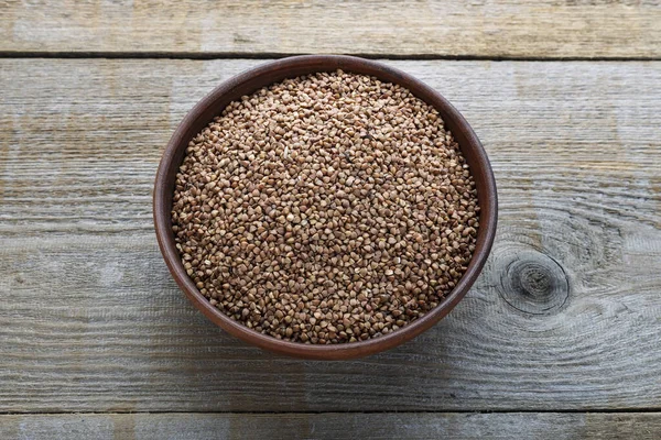 Raw buckwheat in a plate — Stock Photo, Image