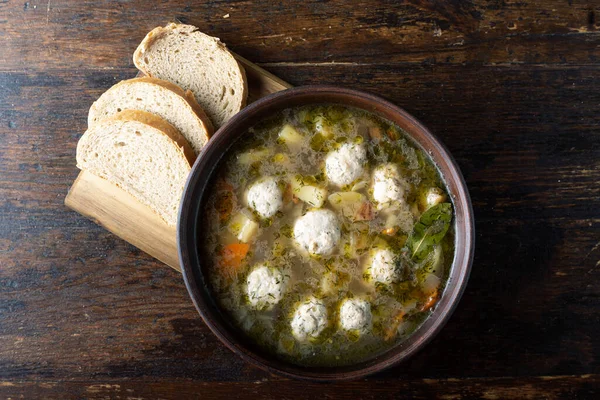 Tasty fresh homemade meatball soup in a clay plate on the tabl — Stock Image Tasty Fresh Homemade Meatball Soup Clay Plate Tabl Stock Photo