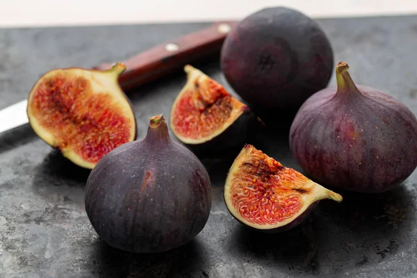 Fresh ripe figs in on a dark background. Healthy food.