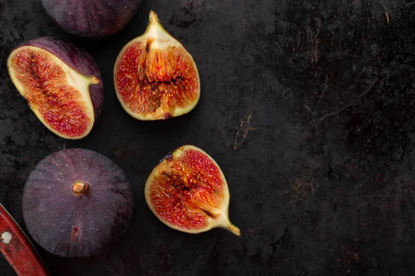 Fresh ripe figs in on a dark background. Healthy food.