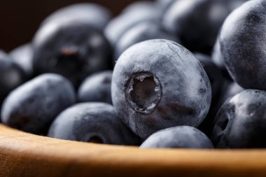 Tahta bir tabakta olgun yaban mersini. Yan görünüş. Yakın plan. Berrie 'nin belirgin dokusu