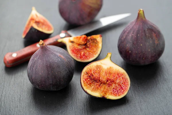 Fresh ripe figs in on a dark background. Healthy food.