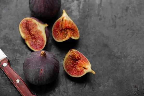 Fresh ripe figs in on a dark background. Healthy food.
