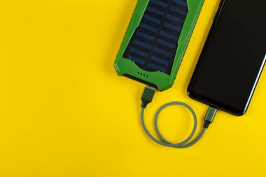 Sarı Arkaplan Görünümünde Güç Bankası ile Akıllı Telefon Şarjı