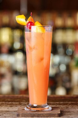 Barda pembe kokteyl, bir restoranda şişelerin bulanık arka planında.