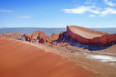 San Pedro de Atacama yakınlarındaki Ay Vadisi'nin çöl manzarası, Şili'nin kuzey kesiminde, bulutlarla kaplı mavi bir gökyüzüne karşı.