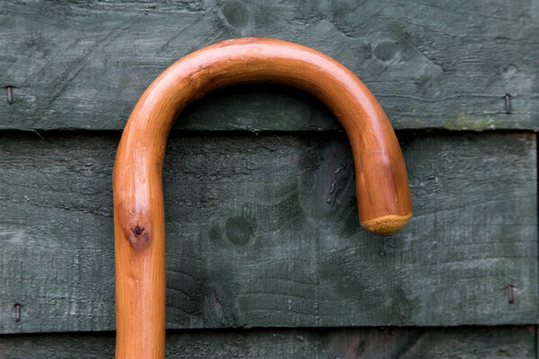 Walking stick handle against an old garden shed