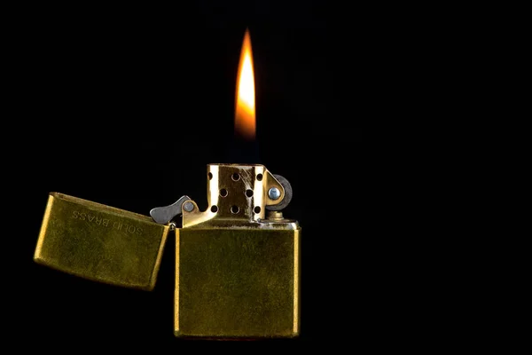 Old Brass Lighter and Flame on a Black Background — Stock Photo, Image