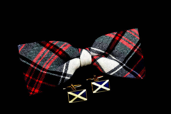 Plaid bow tie and Scottish saltire cuff links isolated against s black background
