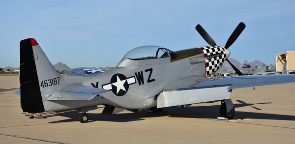 Tucson, USA - March 2, 2018: A vintage World War II-era P-51 Mustang fighter plane on the runway at Davis-Monthan Air Force Base in Tucson, Arizona.