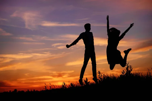 Young Man His Girlfriend Jump Background Sunset Silhouette — Stock Photo, Image