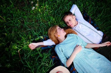 Genç çift çim üzerinde yalan ve sakin ol, yukarıdan görüntülemek.