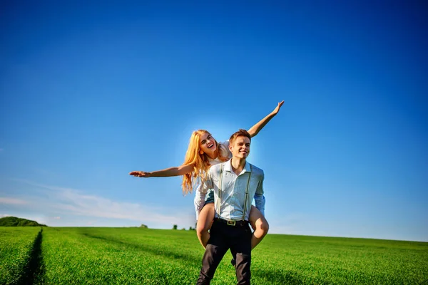 Smiling Man Holding His Back Happy Woman Who Pulls Out — Stock Photo, Image